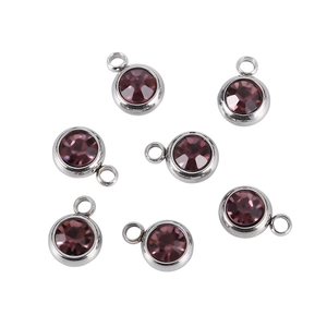 Detailed view of round purple birthstone charms in silver stainless steel settings