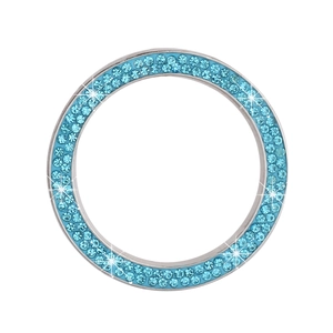 Detail of silver engine start button ring with sparkling blue crystal rhinestones