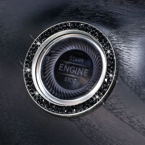 Close-up of car ignition ring with black rhinestones on a silver metal base