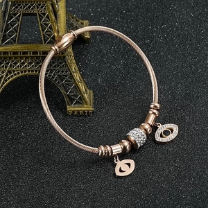 Rose gold stainless steel Evil Eye braided bracelet with magnetic clasp and charms