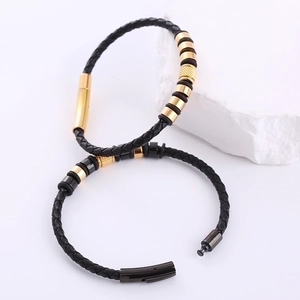 Men's woven leather bracelets with gold and gunmetal beads on white stone props