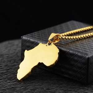 Detail of gold Africa map pendant with brushed finish on black leather jewelry box