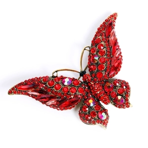 Vintage red crystal butterfly brooch with golden base and sparkling rhinestone wings