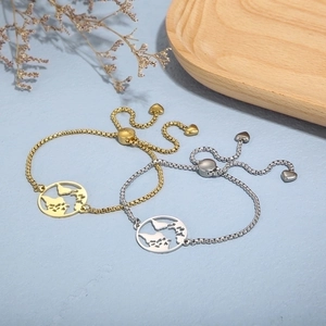 Adjustable stainless steel world map bracelet in gold and silver finish with heart charm