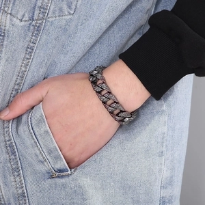 Detail of antique silver gothic skull Cuban chain bracelet with hammered metal texture