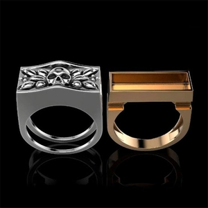 Detailed front view of silver and gold punk skull rings with intricate 3D carvings