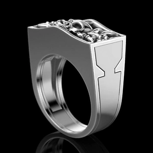 Macro side view of punk skull ring with detailed silver metal relief and gothic geometric frame