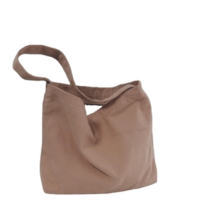 Minimalist tan canvas tote bag with wide shoulder straps in a large capacity design
