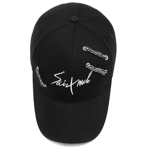Black street style baseball cap with white Saint Malo embroidery and metal rings