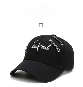 Detail of black cotton baseball cap with white script embroidery and metal chain rings