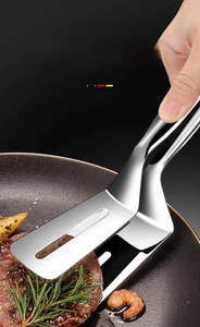Macro shot of a dual-sided 304 stainless steel food tong used for frying steak and fish