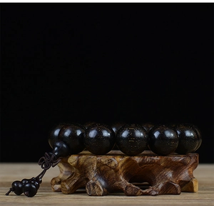 Macro detail of high-quality blood sandalwood beads with fine golden star patterns