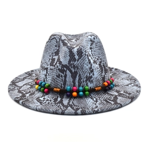 Detail of snakeskin pattern wool felt hat with colorful bohemian beaded ethnic band