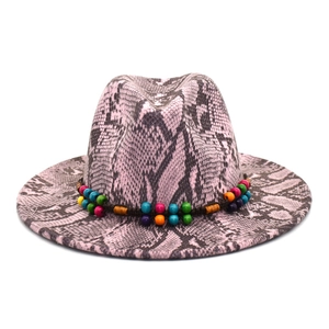 Close-up of pink snake print fedora hat featuring colorful beads and woven rope band