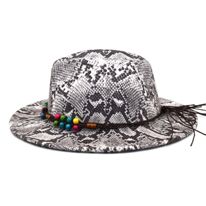Detail of snake skin pattern fedora with colorful beads and bohemian tassel accent