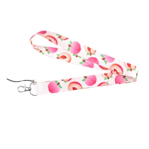 Close-up of white fabric phone lanyard featuring pink peach patterns and a metal lobster clasp