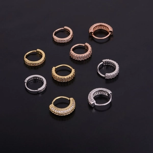 Detailed close-up of zircon hoop earrings in gold, silver, and rose gold finishes
