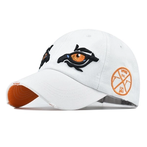 Close-up of dual-eye embroidery and distressed brim details on a white baseball cap