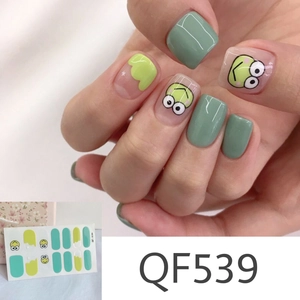 Detail view of mint green matte nail stickers with frog and cloud patterns, model QF539