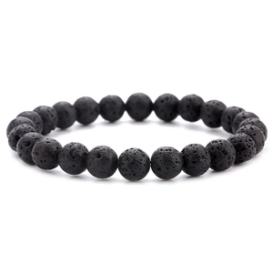 Detailed view of natural black lava stone beads with porous texture for elastic bracelet