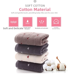 Detail of four colorful soft cotton towels featuring a heart jacquard and raw cotton
