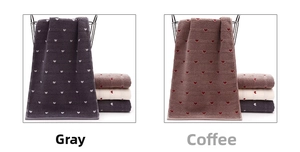 Detail showing grey and brown towels with heart patterns in a black metal basket