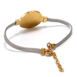 Macro detail of dual-tone 18K gold and silver mesh watchband bracelet with extension chain