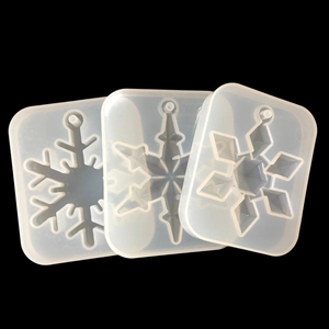 Three snowflake-shaped silicone molds for DIY resin jewelry and decorative ornaments