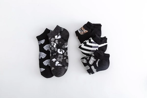Detailed flat lay of cotton crew socks featuring diverse camouflage and geometric patterns