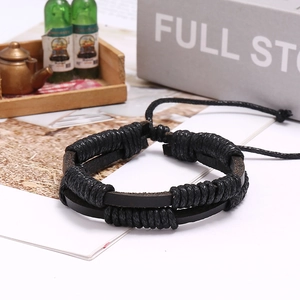 Macro shot of multi-layer black braided leather bracelet with adjustable drawstring closure