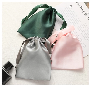 Lustrous satin drawstring bags in dark green, silver, and pink for premium gift storage