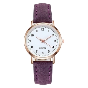Detailed close-up of quartz watch with rose gold case and purple suede leather strap