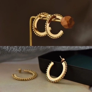 Polished gold beaded edge C-shape hoop earrings in minimalist geometric steel style