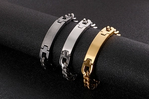Close-up of men's stainless steel ID bracelets in gold, silver, and black finish