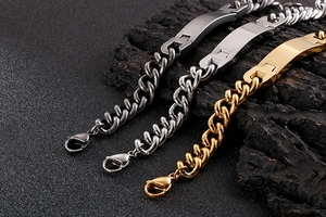 Macro shot of men's stainless steel curb bracelets in black, silver, and gold finish