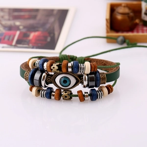 Detail of adjustable evil eye bracelet with green leather bands and multicolored wooden beads