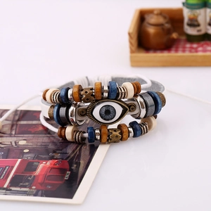 Detailed macro shot of beaded multilayer leather bracelet with a blue evil eye bead