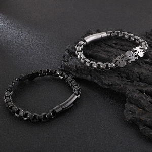Vintage punk skull bracelets in black and silver finishes on dark rock background