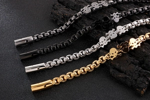 Detailed view of skull bracelets in gold, silver, gun grey, and black stainless steel
