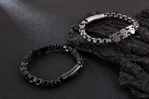 Detailed macro view of vintage skull punk steel bracelets in silver and black finish