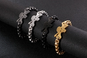 Detail shot of four punk skull and wrench bracelets in gold, silver, and black finishes