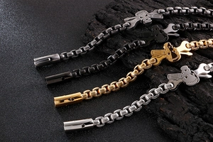 Detail of punk skull bracelet in silver, gold and black finish with cross charms