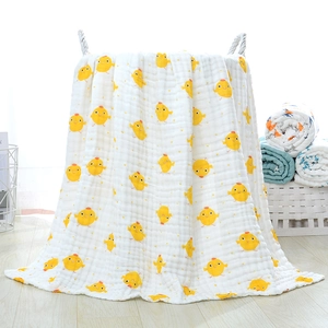 Close-up of soft multi-layer cotton gauze baby blanket with cute yellow chick prints