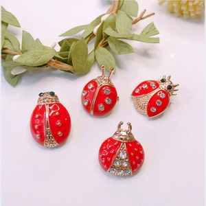 Vibrant red enamel ladybug brooches with sparkling rhinestones and gold-tone finish