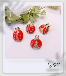Set of four red ladybug brooches with gold plating and sparkling rhinestones