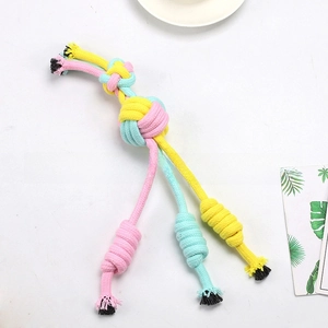 Detail view of durable pink and yellow cotton rope dog chew toy with sturdy knots