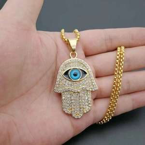 Gold Hamsa Hand pendant necklace with blue eye and sparkling crystal rhinestones