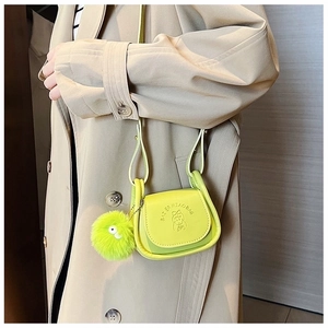 Mini green leather crossbody bag with cartoon girl embossing and fluffy keychain