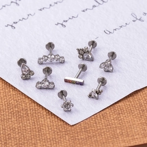G23 Titanium labret studs with zircon in flower and teardrop shapes on elegant card