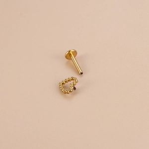 Titanium gold beaded heart stud earring with flat back threaded post on neutral background